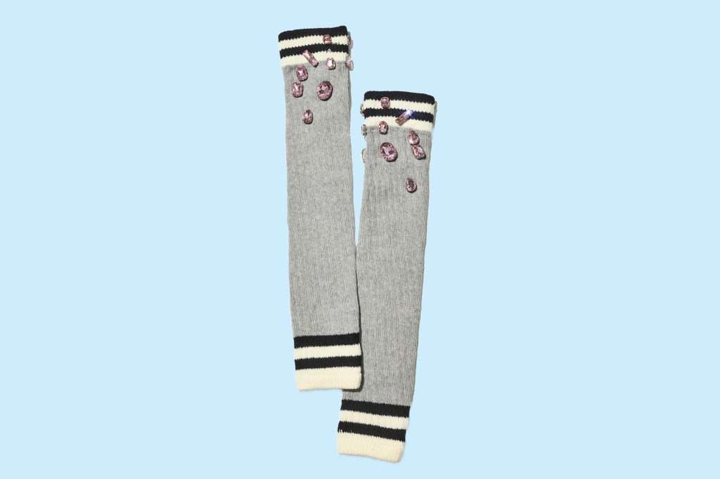 A pair of gray socks with black stripes and pink diamonds